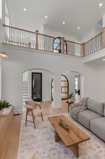 a living room with furniture and a potted plant