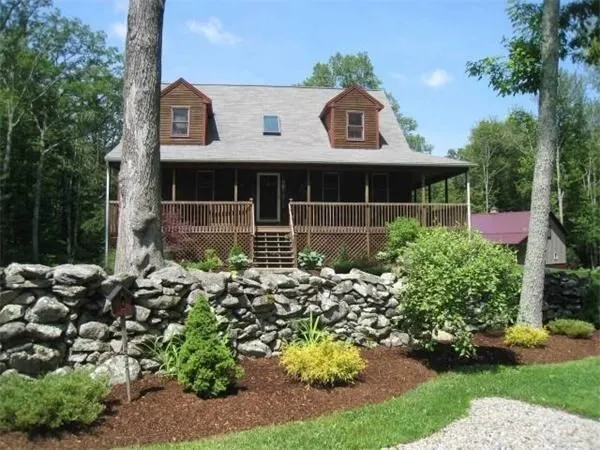 a view of a chair and table in front of house