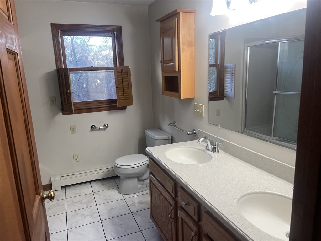 985 Glebe Street Taunton, MA 02780 - Photo 12 of 23 a bathroom with a sink a toilet and mirror