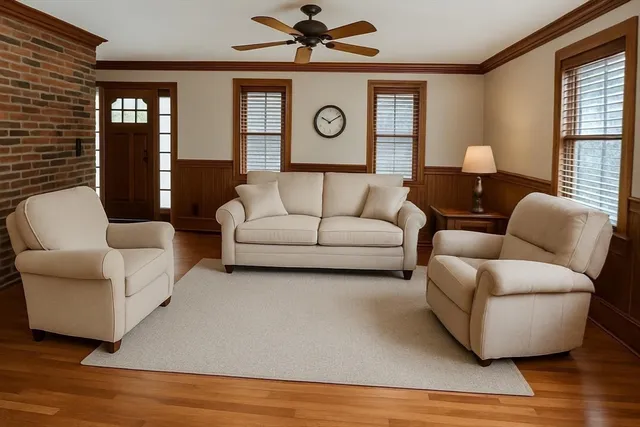 a living room with furniture and wooden floor