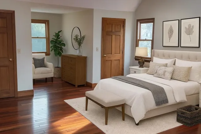 a bedroom with a bed a mirror and a large window