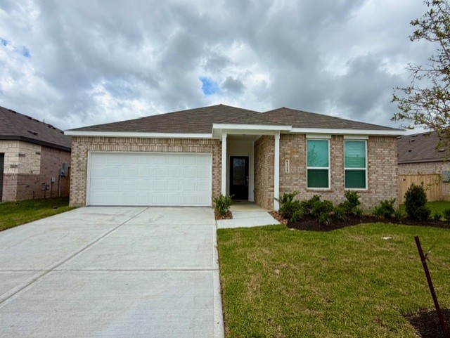 9315 Zander Drive Baytown, TX 77521 - Photo 1 of 21 a front view of a house with garden