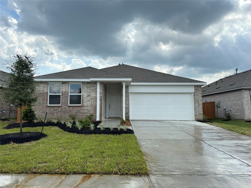 9315 Zander Drive Baytown, TX 77521 - Photo 2 of 21 a front view of a house with a garden and yard