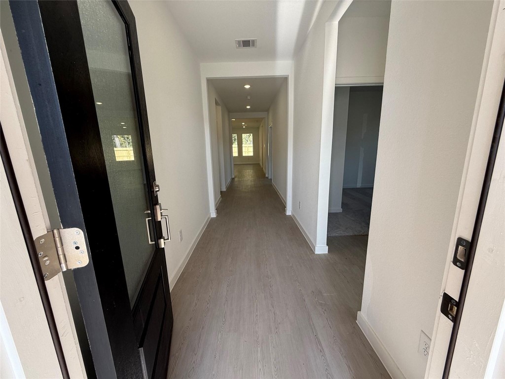 9315 Zander Drive Baytown, TX 77521 - Photo 3 of 21 a view of a hallway with wooden floor