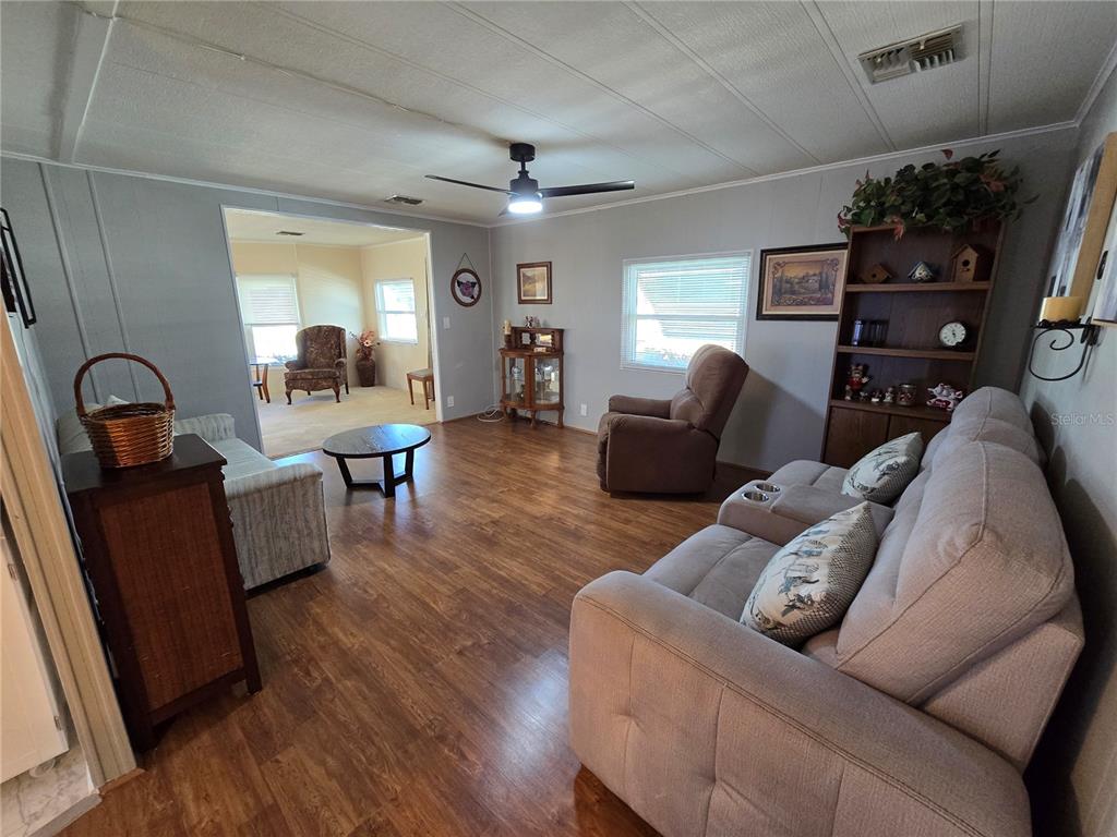 1535 Caribbean Road Sebring, FL 33870 - Photo 13 of 26 a living room with furniture and wooden floor