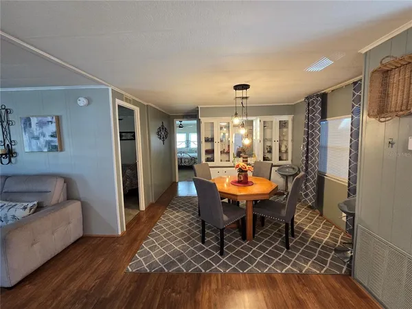 a dining room with furniture a rug and wooden floor