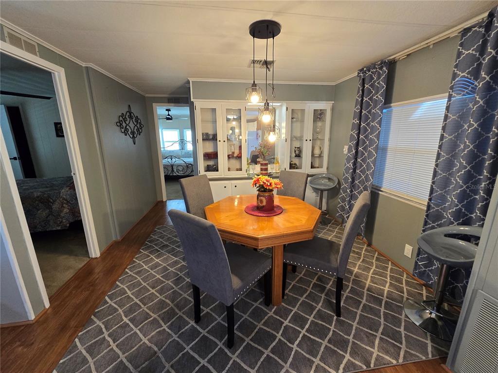 1535 Caribbean Road Sebring, FL 33870 - Photo 15 of 26 a view of a dining room with furniture and wooden floor