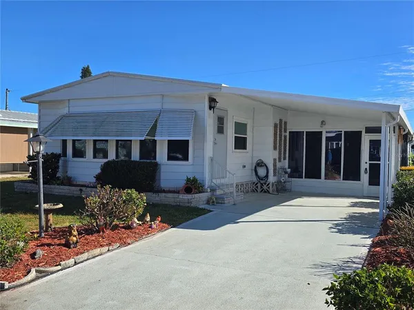 a front view of a house with sitting area
