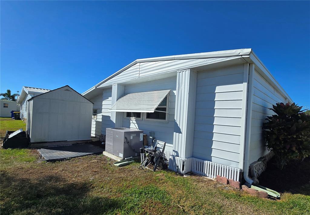 1535 Caribbean Road Sebring, FL 33870 - Photo 20 of 26 a view of backyard with a barn and a cactus plant