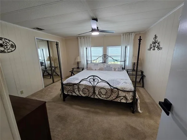 a bedroom with a bed and a chandelier