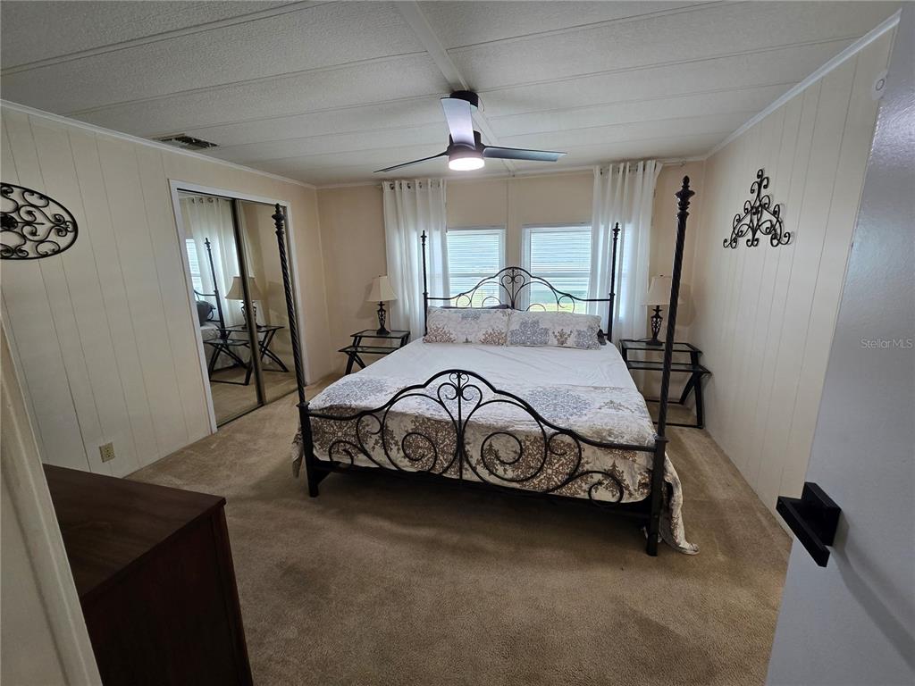 1535 Caribbean Road Sebring, FL 33870 - Photo 2 of 26 a bedroom with a bed and a chandelier