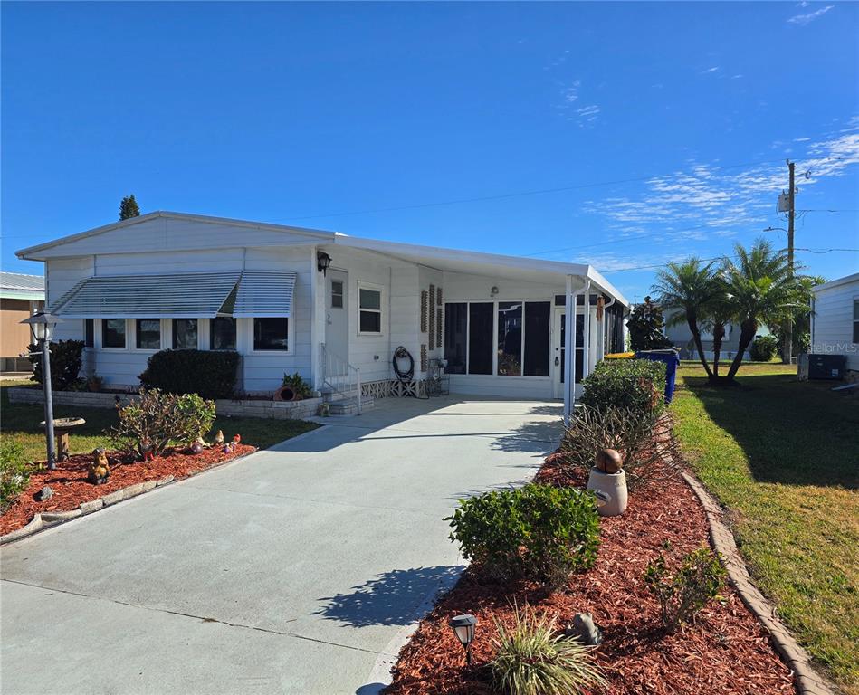 1535 Caribbean Road Sebring, FL 33870 - Photo 22 of 26 a front view of a house with garden