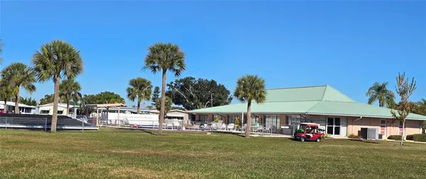 a view of a swimming pool with a table and chairs under an umbrella