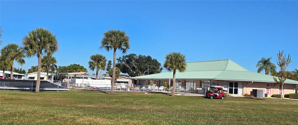 1535 Caribbean Road Sebring, FL 33870 - Photo 23 of 26 a view of a swimming pool with a table and chairs under an umbrella