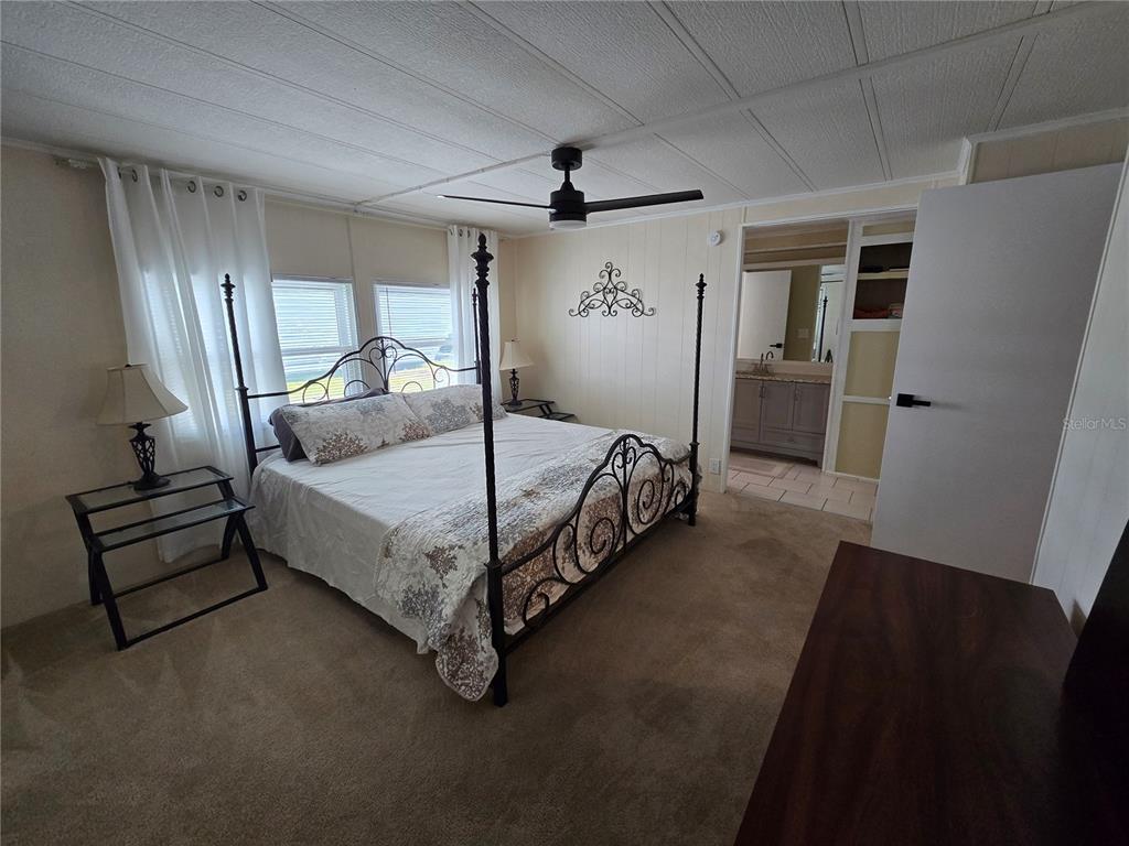 1535 Caribbean Road Sebring, FL 33870 - Photo 3 of 26 a bedroom with a bed and a mirror
