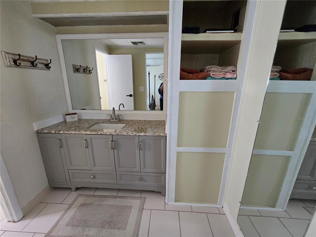1535 Caribbean Road Sebring, FL 33870 - Photo 4 of 26 a bathroom with a granite countertop sink and a mirror