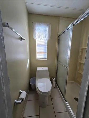 a bathroom with a toilet and a shower