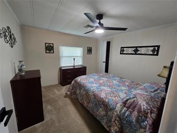 a bedroom with a bed and a dresser