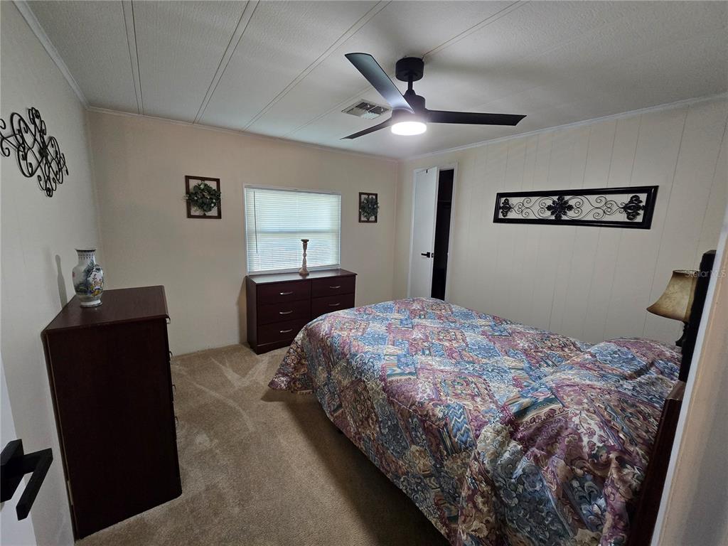 1535 Caribbean Road Sebring, FL 33870 - Photo 6 of 26 a bedroom with a bed and a dresser
