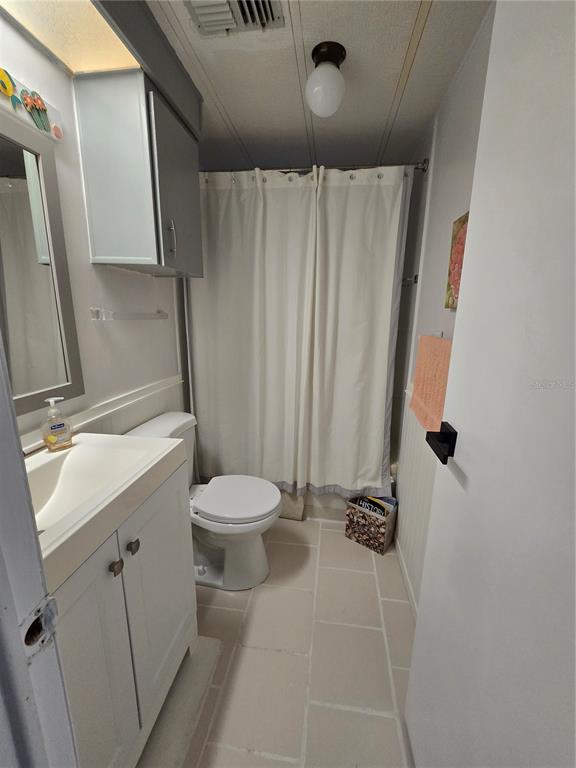 1535 Caribbean Road Sebring, FL 33870 - Photo 7 of 26 a bathroom with a sink a toilet a mirror and shower
