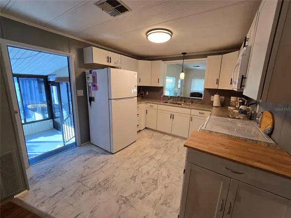 a kitchen with refrigerator and cabinets