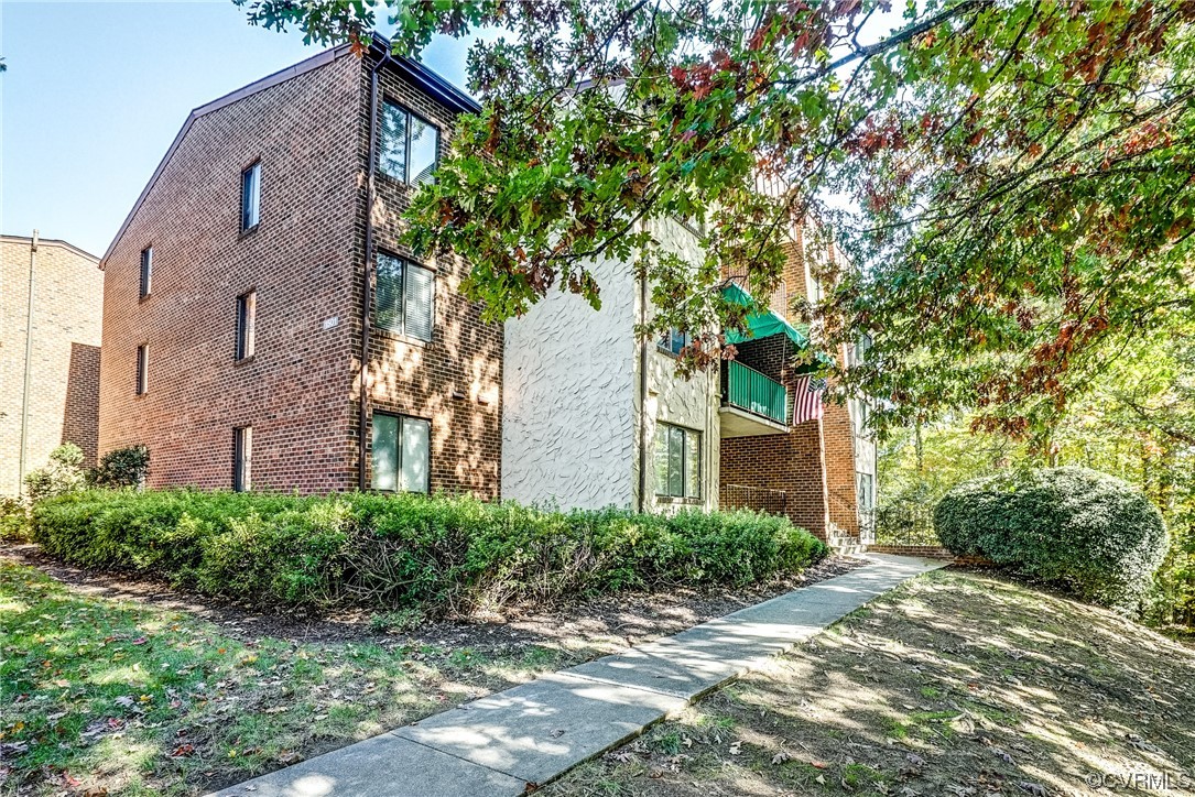 1501 Thistle Road, Unit 103 Henrico, VA 23238 - Photo 1 of 27 a front view of a house with garden