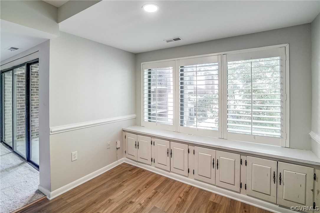 1501 Thistle Road, Unit 103 Henrico, VA 23238 - Photo 11 of 27 a view of an empty room with wooden floor and a window
