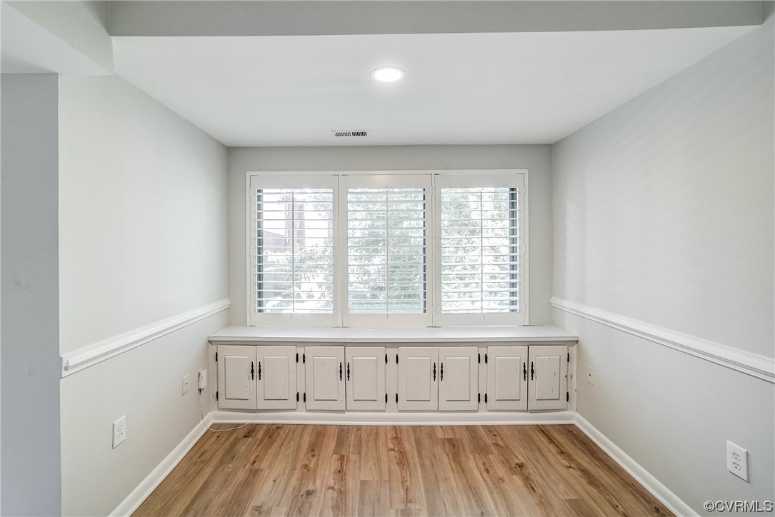 1501 Thistle Road, Unit 103 Henrico, VA 23238 - Photo 12 of 27 a view of an empty room with wooden floor and a window