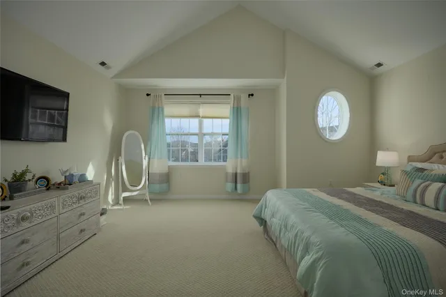 a bedroom with a bed and a large window