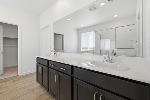 a bathroom with a double vanity sink and a mirror