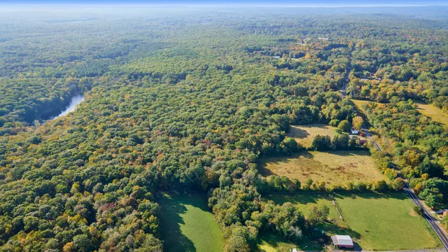 an aerial view of a houses with a yard