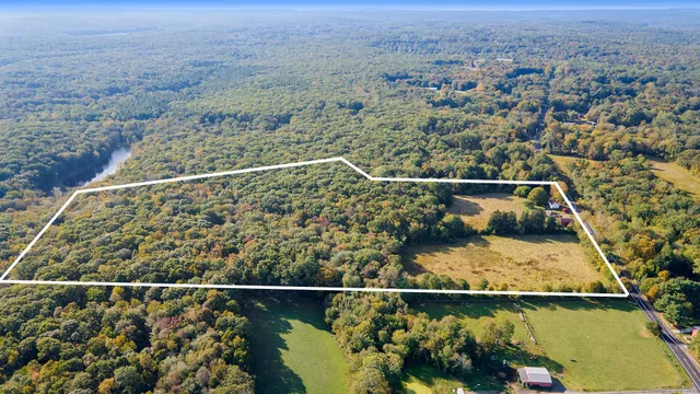 an aerial view of a houses with a yard