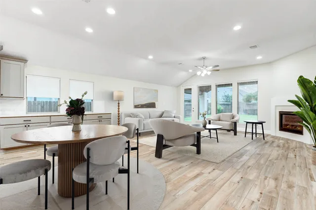 a view of a a dining room with furniture window and wooden floor