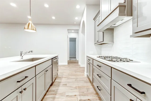 a kitchen with cabinets and appliances