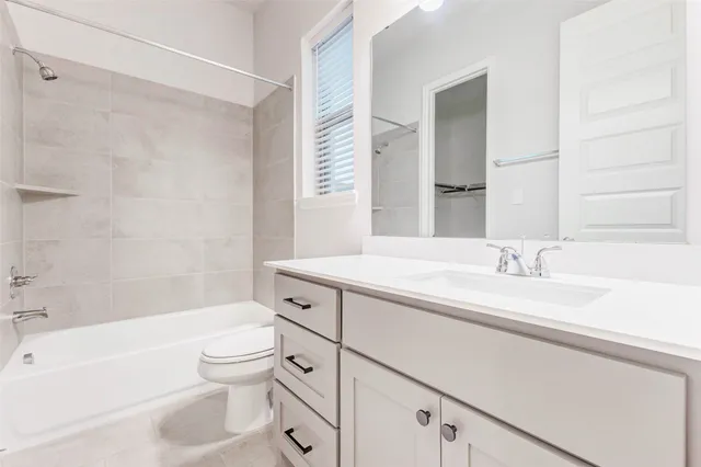 a bathroom with a sink a toilet and a bathtub
