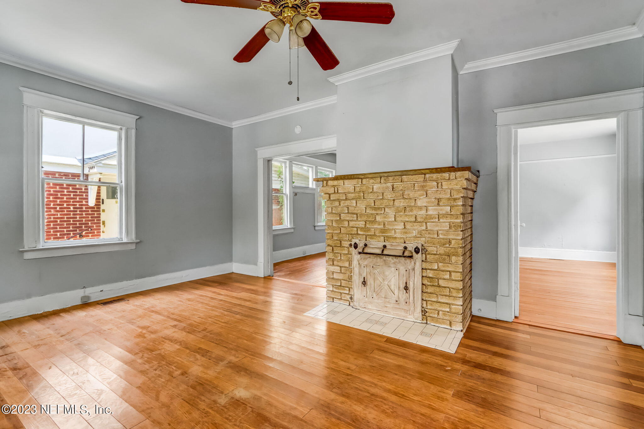 2805 College Street Jacksonville, FL 32205 - Photo 12 of 40 an empty room with wooden floor chandelier fan and windows
