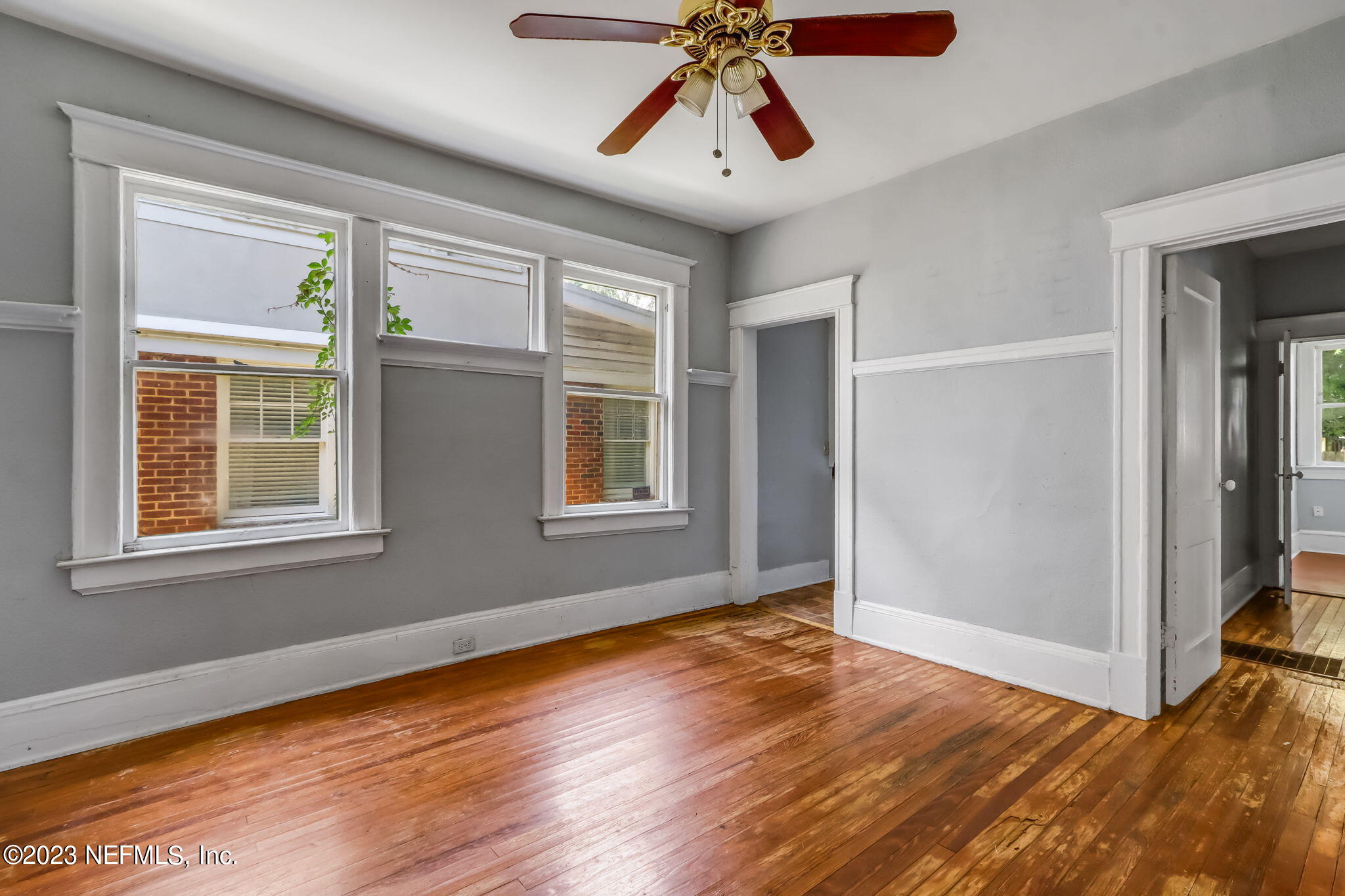 2805 College Street Jacksonville, FL 32205 - Photo 13 of 40 an empty room with wooden floor chandelier and windows