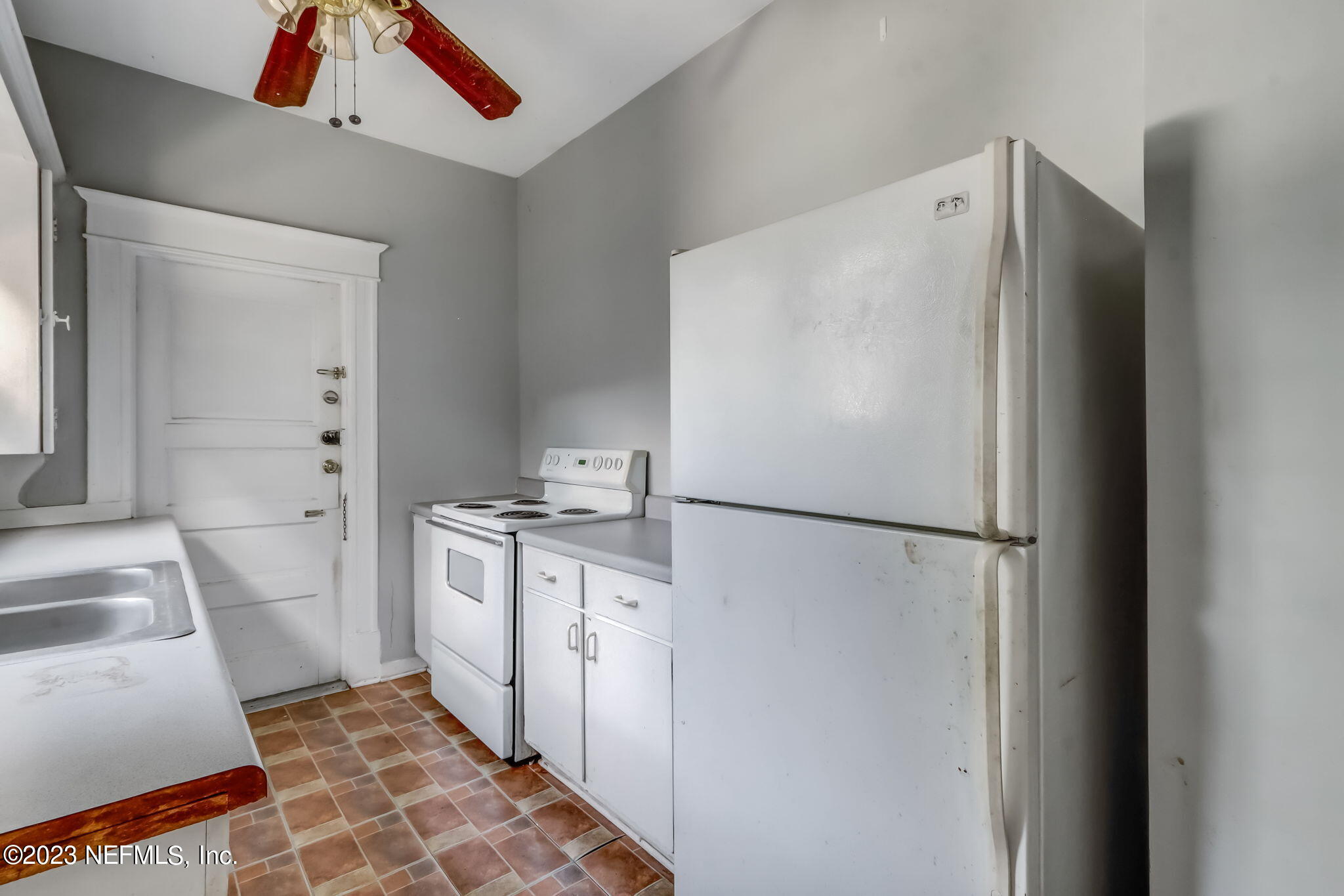 2805 College Street Jacksonville, FL 32205 - Photo 6 of 40 a white refrigerator freezer and a stove sitting inside of a kitchen