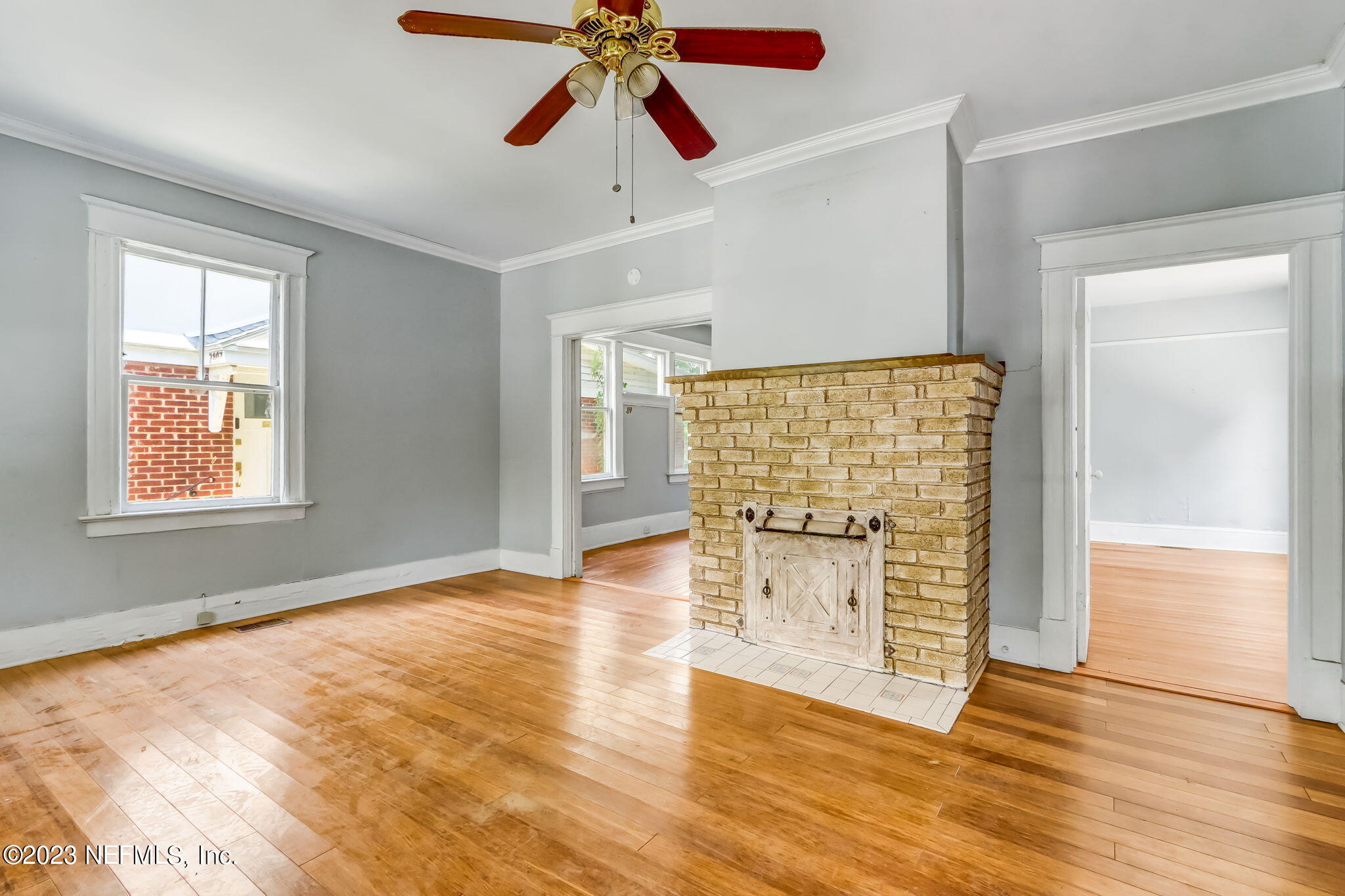2805 College Street Jacksonville, FL 32205 - Photo 9 of 40 an empty room with wooden floor chandelier fan and windows