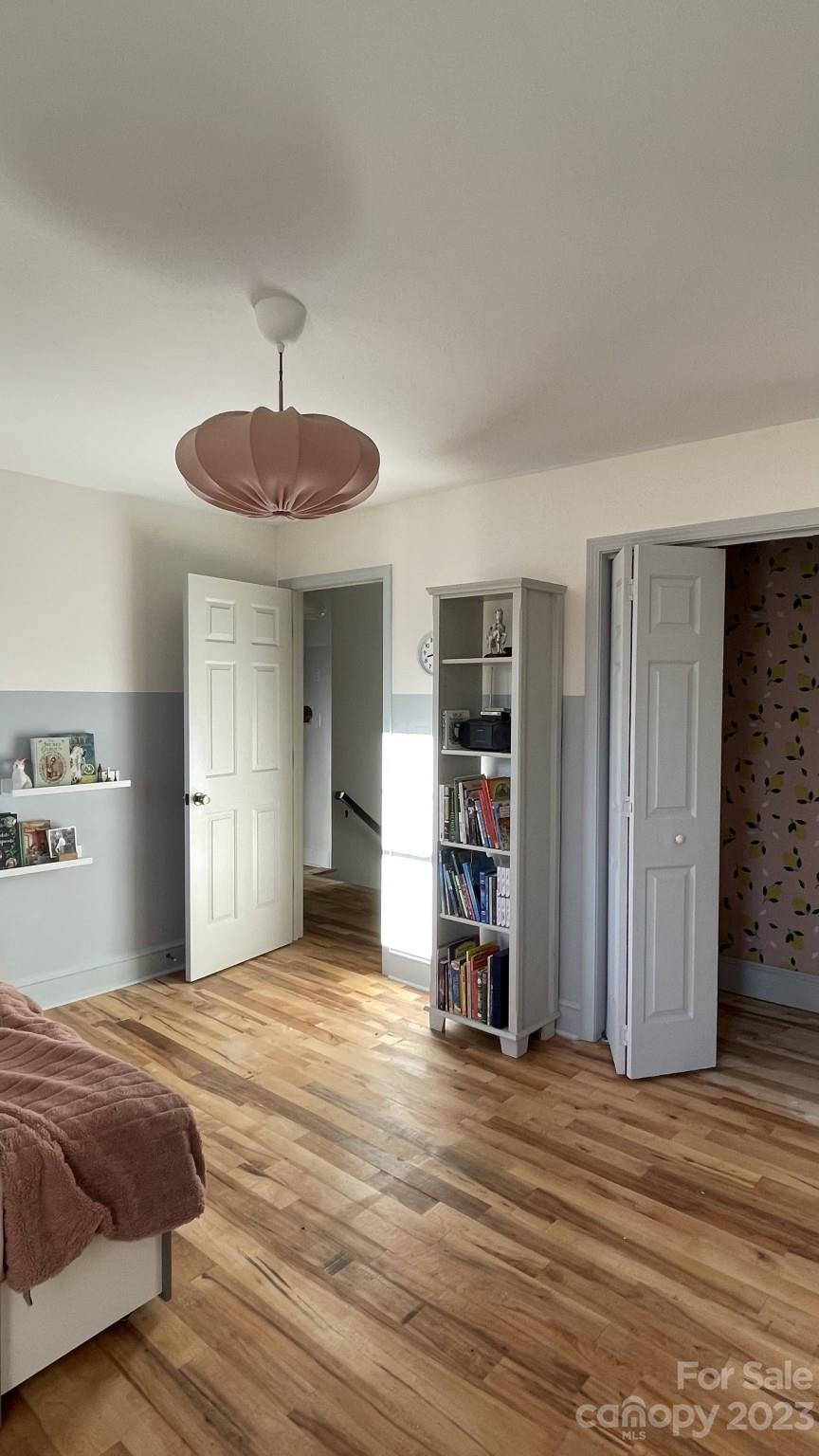 4101 Coleman Drive Charlotte, NC 28215 - Photo 10 of 34 a bedroom with a bed and a chandelier