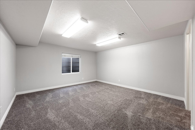 7 Reflection Way St. George, UT 84770 - Photo 26 of 54 Carpeted spare room with a textured ceiling and baseboards