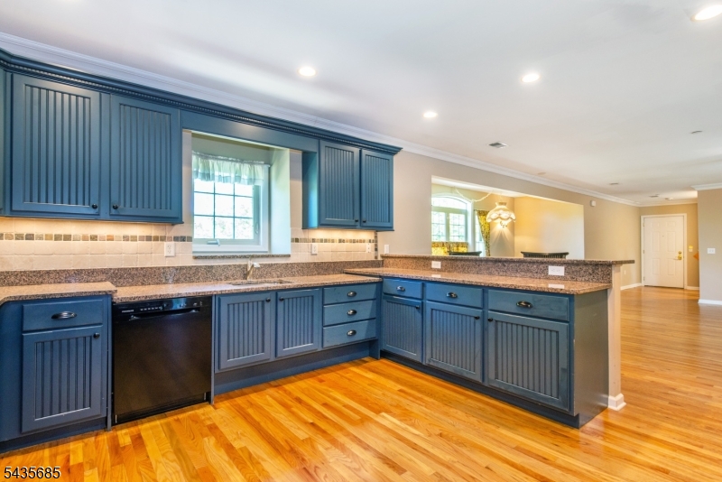 16 Main Street Sparta, NJ 07871 - Photo 5 of 33 a large kitchen with granite countertop wooden cabinets a sink and dishwasher