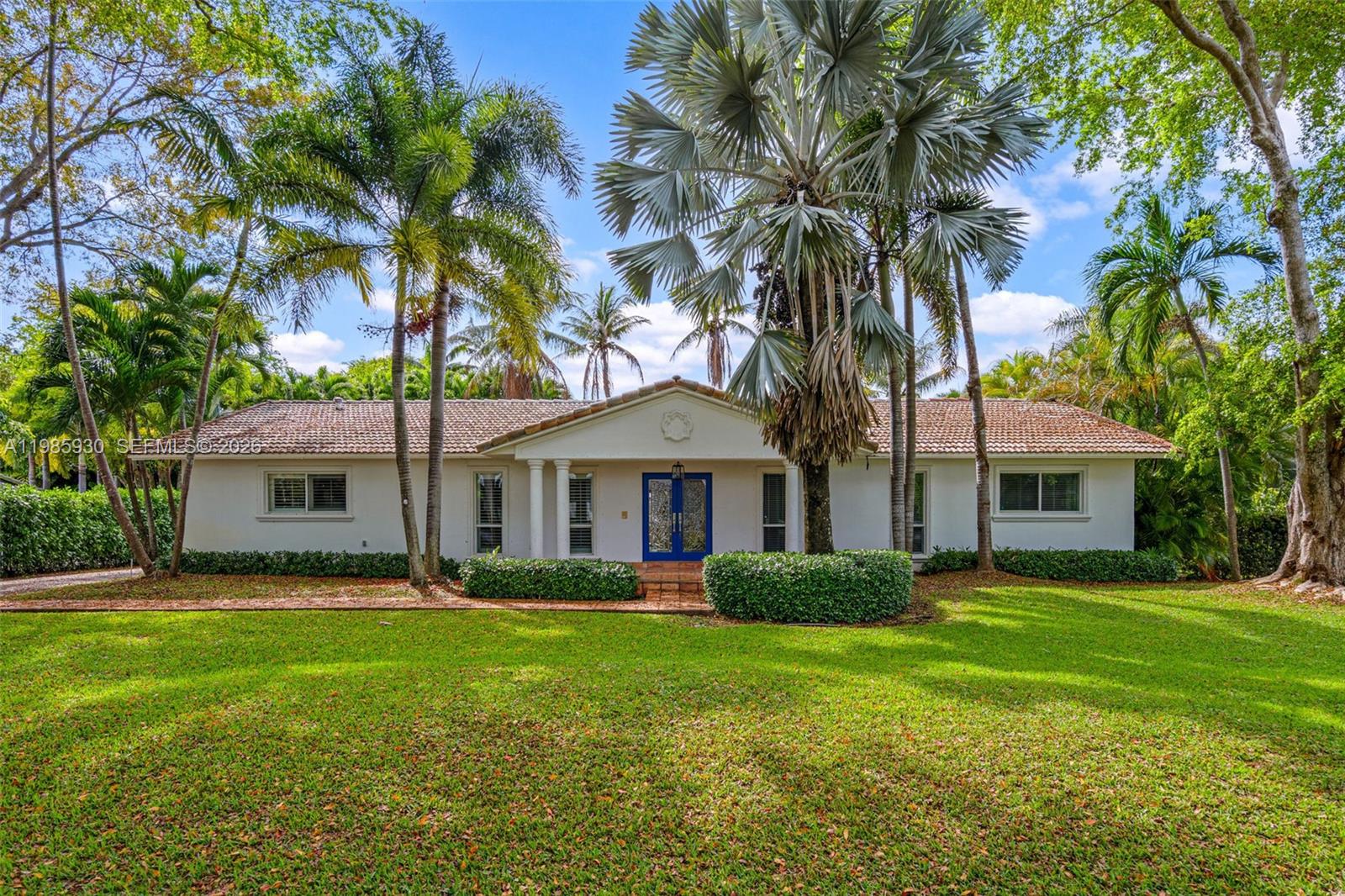 13276 Southwest 58th Court Pinecrest, FL 33156 - Photo 1 of 67 a front view of house with yard and green space