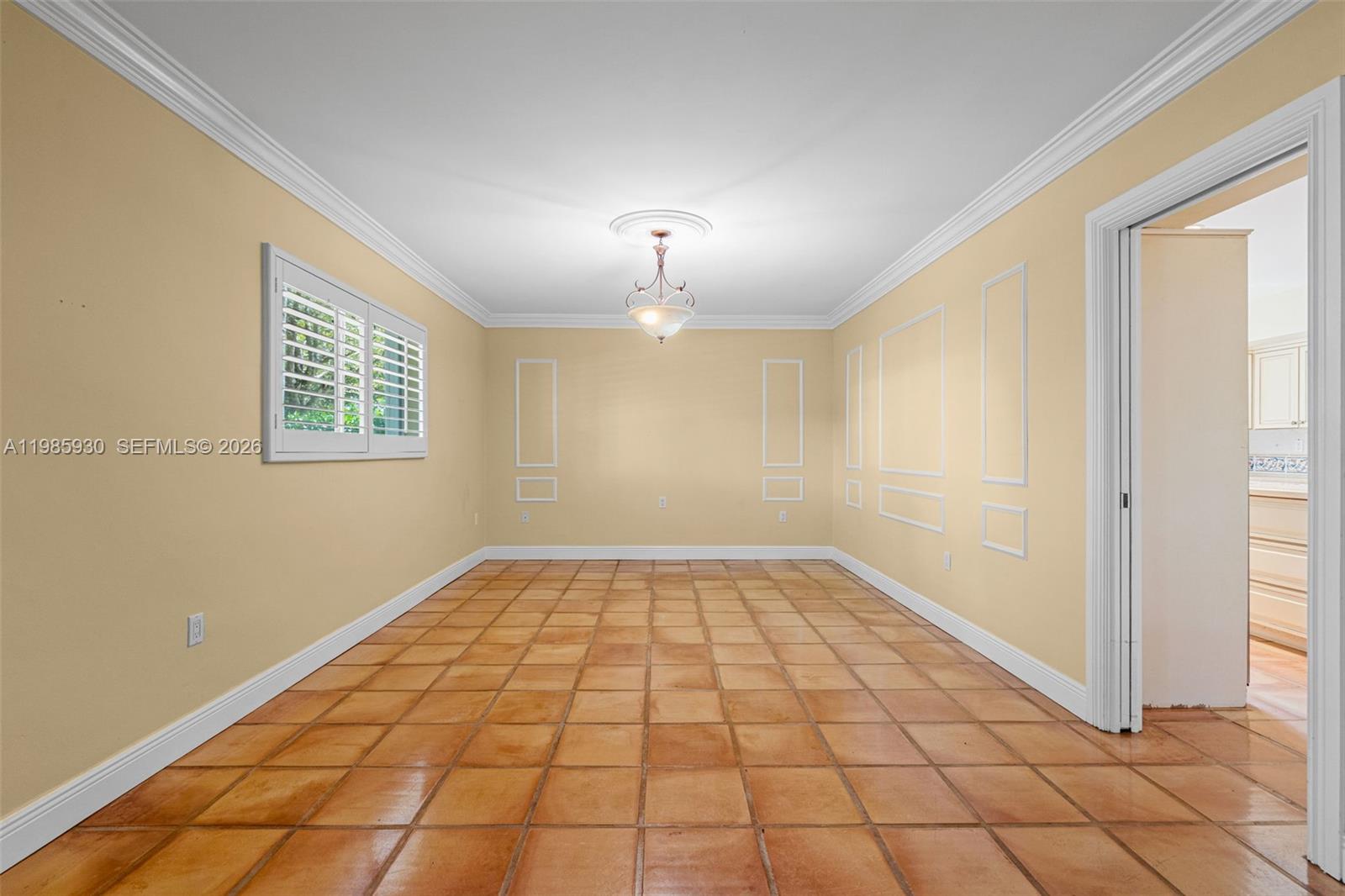 13276 Southwest 58th Court Pinecrest, FL 33156 - Photo 11 of 67 a view of an empty room with window and chandelier fan