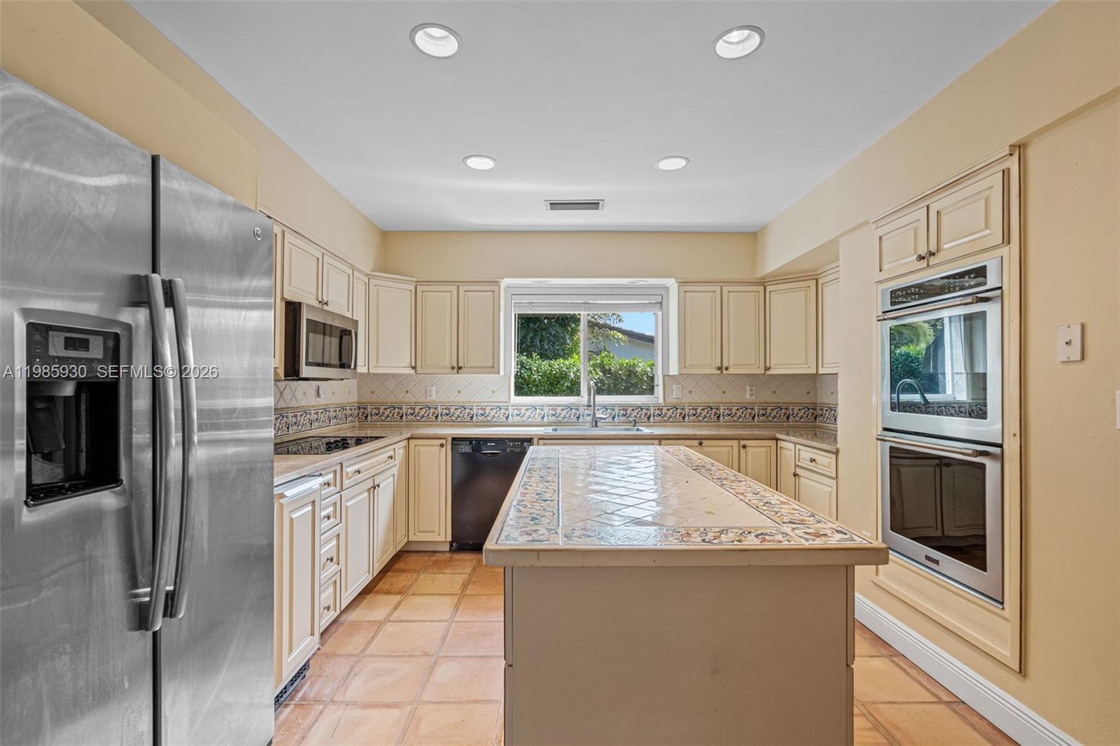 13276 Southwest 58th Court Pinecrest, FL 33156 - Photo 24 of 67 a kitchen with stainless steel appliances granite countertop a refrigerator and a stove top oven