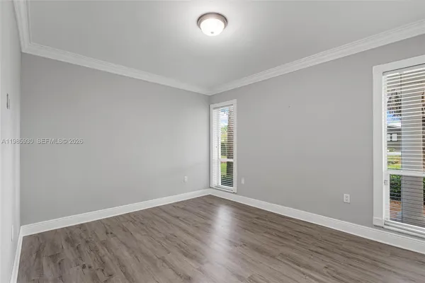 an empty room with wooden floor and closet