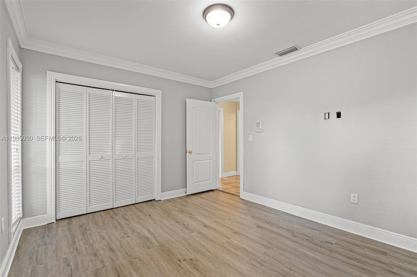 13276 Southwest 58th Court Pinecrest, FL 33156 - Photo 30 of 67 a view of an empty room with wooden floor