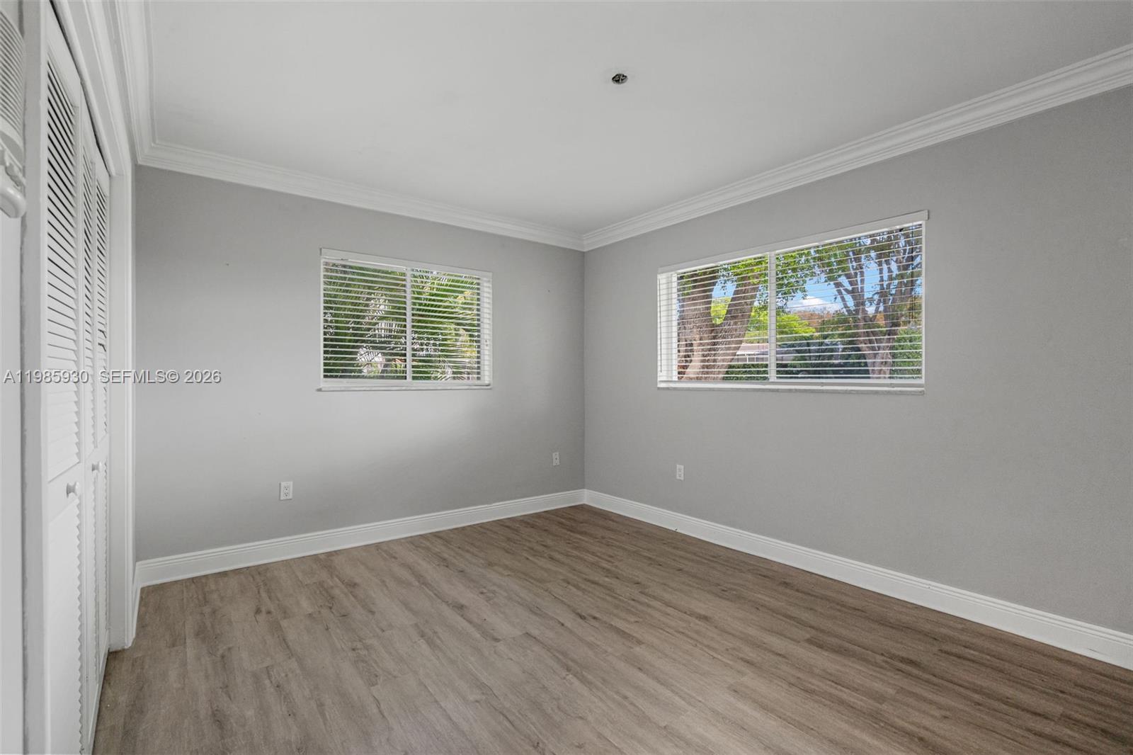 13276 Southwest 58th Court Pinecrest, FL 33156 - Photo 36 of 67 a view of an empty room with wooden floor and a window