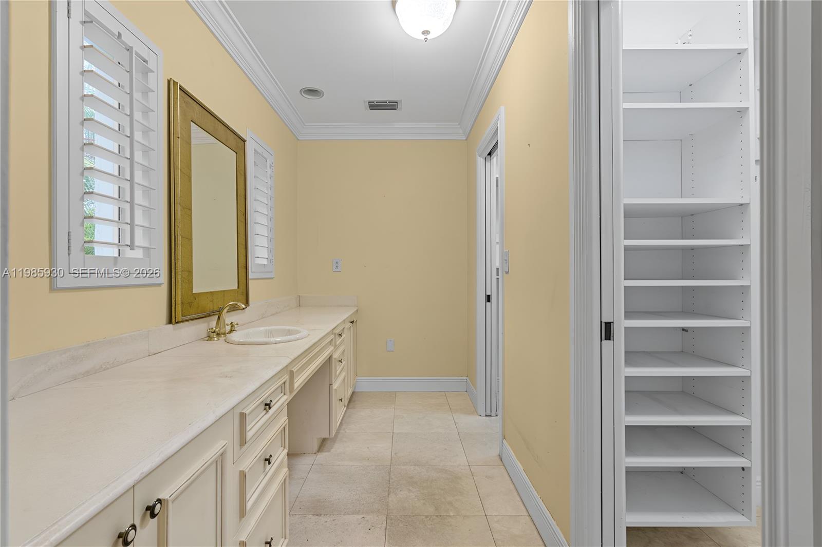 13276 Southwest 58th Court Pinecrest, FL 33156 - Photo 43 of 67 a spacious bathroom with a granite countertop sink and a mirror