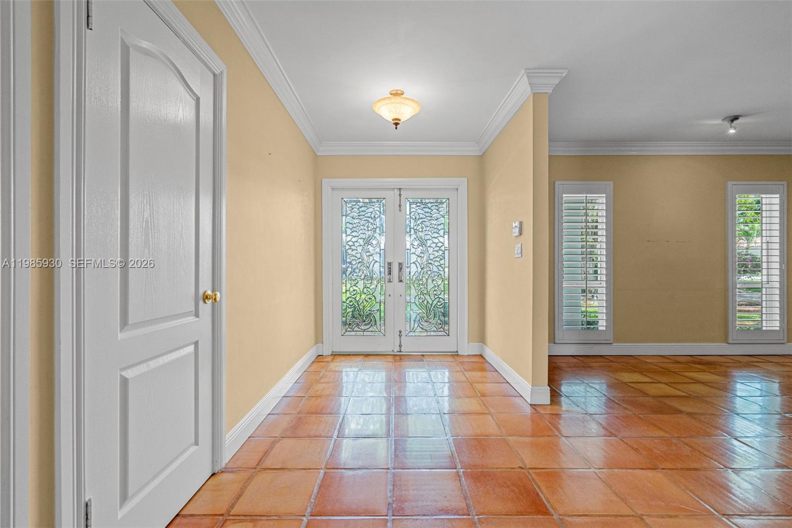 13276 Southwest 58th Court Pinecrest, FL 33156 - Photo 6 of 67 a view of a hallway with windows and chandelier